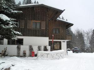 a house in the snow with graffiti on it at Holiday Home Alpenchalet Silbertal by Interhome in Silbertal