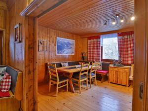 a dining room with a wooden table and chairs at Holiday Home Alpenchalet Silbertal by Interhome in Silbertal +25 photos