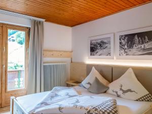 a bedroom with a bed and a window at Holiday Home Alpenchalet Silbertal by Interhome in Silbertal
