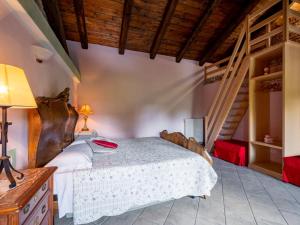 a bedroom with a bed and a staircase at Holiday Home Antica Cascina by Interhome in Castagnole Lanze