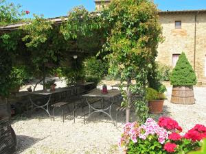 a garden with tables and plants and flowers at Holiday Home Linearis J by Interhome in SantʼAppiano