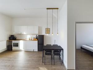 a kitchen and dining room with a table and chairs at Großzügige Wohnung mit Balkon in Magdeburg