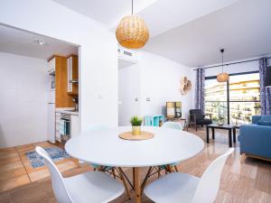 a dining room and living room with a white table and chairs at Apartment Cala Mora by Interhome in Moraira