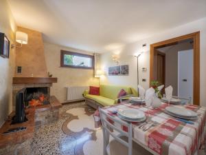 a living room with a table and a fireplace at Holiday Home Villa Stelis by Interhome in Sequals