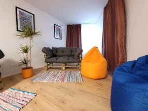 a living room with a chair and a rug at 2 Zimmer, 4 Person, Balkon in Essen