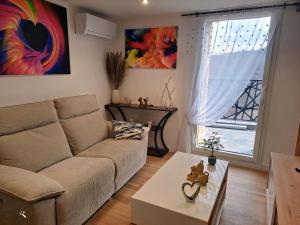 a living room with a couch and a table at La Marmotte in La Bastide