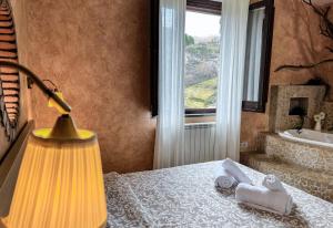 a bathroom with a bed and a lamp and a window at Guarda Che Luna in Sasso di Castalda +86 photos