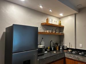 a kitchen with a stainless steel refrigerator and a sink at Apartamento nuevo en zona romántica a 3 cuadras de la playa in Puerto Vallarta +4 photos