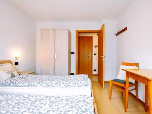 a bedroom with a bed and a table and a desk at Apartment Stabler by Interhome in Pera