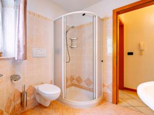 a bathroom with a shower with a toilet and a sink at Apartment Stabler by Interhome in Pera