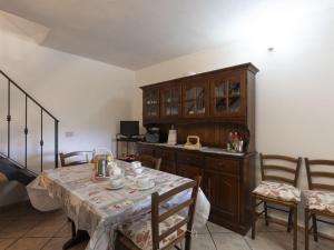 a kitchen with a table and chairs and a cabinet at Holiday Home Villetta Paola - IMP232 by Interhome in Caramagna Ligure +26 photos