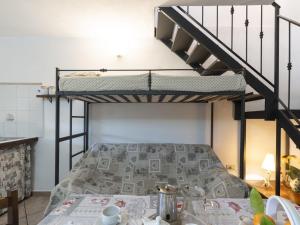 a bedroom with a bunk bed and a table at Holiday Home Villetta Paola - IMP232 by Interhome in Caramagna Ligure