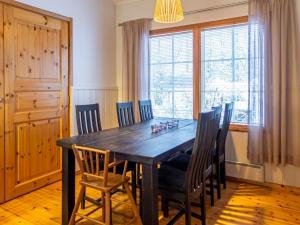 a dining room with a black table and chairs at Holiday Home Katinkulma 2 by Interhome in Vuokatti