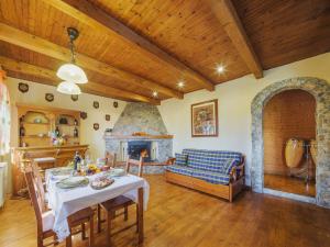 a living room with a table and a fireplace at Chalet Mare e Monti by Interhome in Antona
