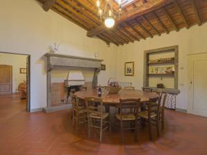 a dining room with a table and a fireplace at Holiday Home Reggine-3 by Interhome in Panzano