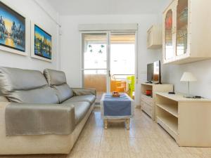 a living room with a couch and a tv at Apartment Portofino IV by Interhome in Oropesa del Mar +13 photos