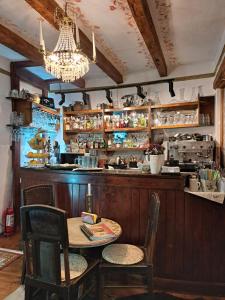 a dining room with a table and a bar at Casa Cositorarului Boutique Pension in Sighişoara