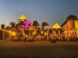 a building on the beach at night with lights at Hotel Budamar Zipolite in Zipolite