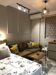 a living room with a couch and a table at Family Adventure at Pazar in Tirana +14 photos