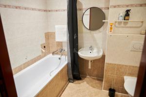 a bathroom with a bath tub and a sink at Sunny apartment Trutnov in Trutnov +20 photos