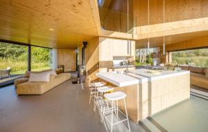 a kitchen and living room with a counter and chairs at 3 Bedroom Lovely Home In Warten in Warten