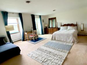 a bedroom with a bed and a table and a chair at Daydream Mountain Art Chateau in Catskill +51 photos
