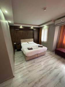 a bedroom with a large bed in a room at Vero Hotel in Konak +5 photos
