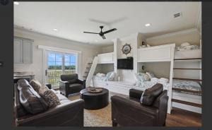 a living room with two bunk beds and two chairs at 2 Abalone Ln, New Construction, Luxury Finishes, Pool, Game Room in Hilton Head Island