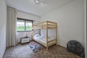 a bedroom with a bunk bed and a window at Pontinha Typical by Homing in Lisbon
