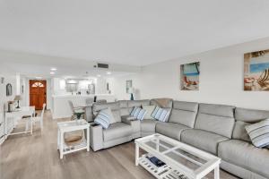 a living room with a couch and a table at Magnificent Gulf Front Condo Located Directly on the Ocean! condo in Indian Rocks Beach
