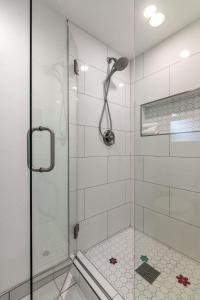 a bathroom with a shower with a glass door at Chic La Jolla Studio Steps to Ocean & Dining in San Diego