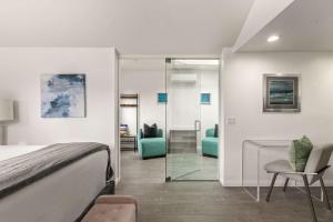 a bedroom with a bed and a mirror at Chic La Jolla Studio Steps to Ocean & Dining in San Diego