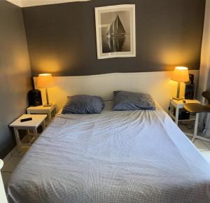 a bedroom with a large bed with two pillows at Résidence Les Grands Pins - maeva Home - 2 Pièces 4 Personnes Sélection MAE-6962 in Maubuisson +8 photos