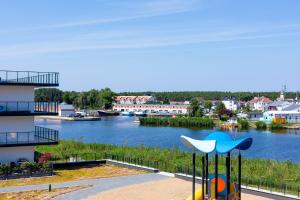 a playground with a view of a river at Apolonia apartament II- SPA in Dziwnów