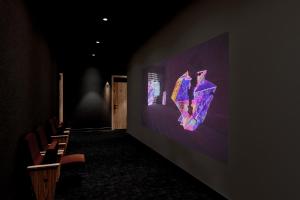a dark room with chairs and a wall with a screen at SonoLux in Montréal