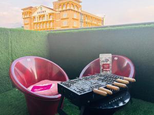 a grill with a bunch of hot dogs on it at Dun Haven Height in Dehradun