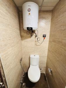 a bathroom with a toilet and a water tank at Dun Haven Height in Dehradun