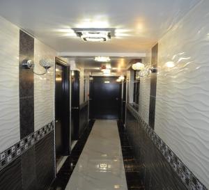 a hallway in a hotel with a black door at Skylark Hostel in Hong Kong