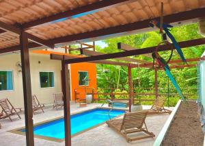 a house with a pool and a swing at Casa da Farofa in Morro de São Paulo