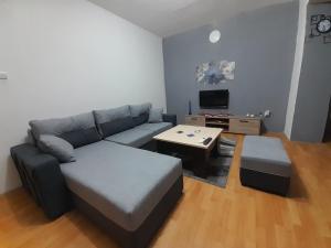 a living room with a couch and a coffee table at Kocovski Apartment in Bitola +6 photos