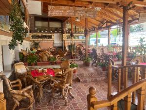 a restaurant with a table and chairs in a room at Hotel Lazur in Kiten