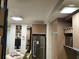 a kitchen with a stainless steel refrigerator in a room at CASA no Centro de Nao Me Toque in Não Me Toques