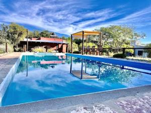 a swimming pool with blue water in front of a house at Cielos Abiertos in La Paz