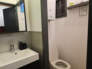 a bathroom with a white toilet and a sink at Wali's Nature Bliss Dinant Givet in Waulsort