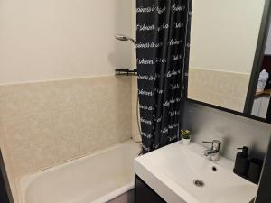 a bathroom with a sink and a tub and a shower at Wali's Nature Bliss Dinant Givet in Waulsort