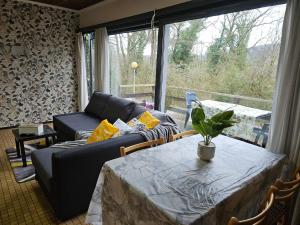 a living room with a table and a couch at Wali's Nature Bliss Dinant Givet in Waulsort
