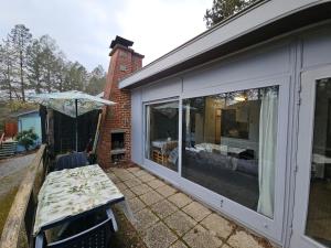 a patio with a table and an umbrella at Wali's Nature Bliss Dinant Givet in Waulsort