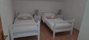 twee witte stapelbedden in een kleine kamer bij Villa Aida in Bihać +17 foto's