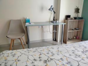 a desk in a bedroom with a bed and a chair at Sunny Nest in Sparta