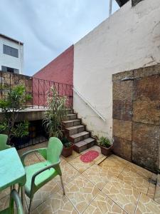 a patio with a table and chairs and stairs at Excelente casa a 700 m da COP30 in Belém +47 photos